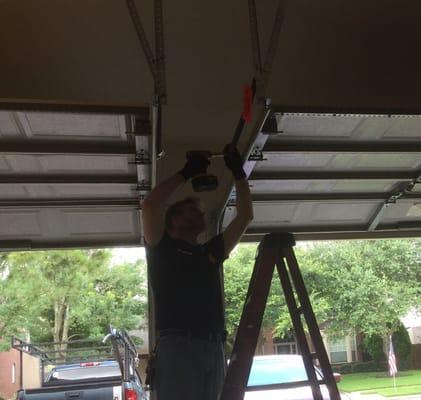 Replacing bad pulleys on a garage door.