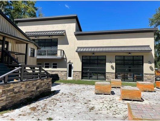 Custom detached garage, featuring glass doors, upper level workout room