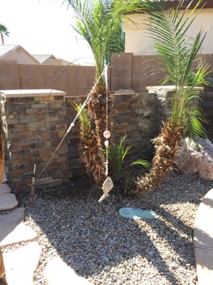 Privacy wall with ledger stone blocking pool equipment. Completed job.