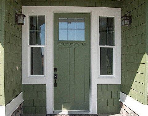 8 foot craftsman door with dentil trim installed surrounded by shingles and stone