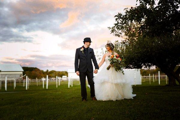 Bride and Groom walking in the apple orchard