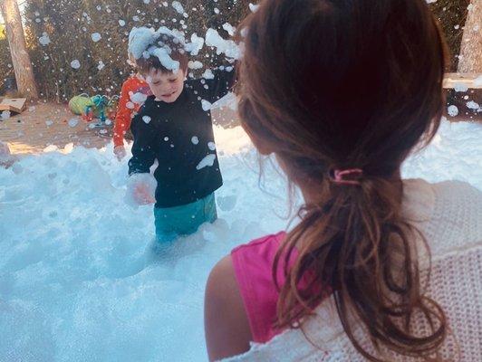 The kids playing in the bubbles.