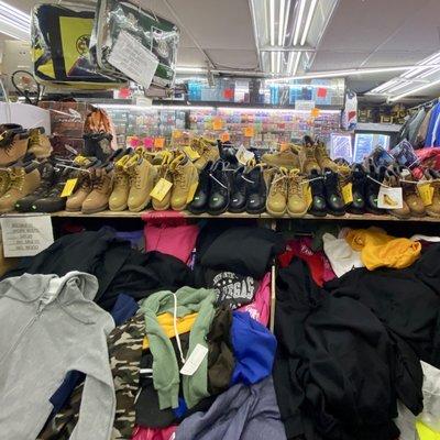 Piles of sweats and work boots for sale inside