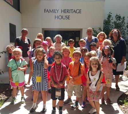 visiting summer campers take a photo with Co-founder Mrs. Fredi Brown