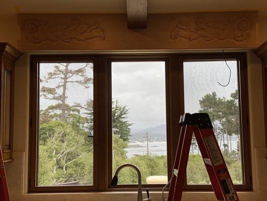 Carving on wood valance above kitchen sink before staining