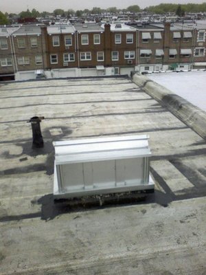 Newly installed flat rubber roof with new skylight.