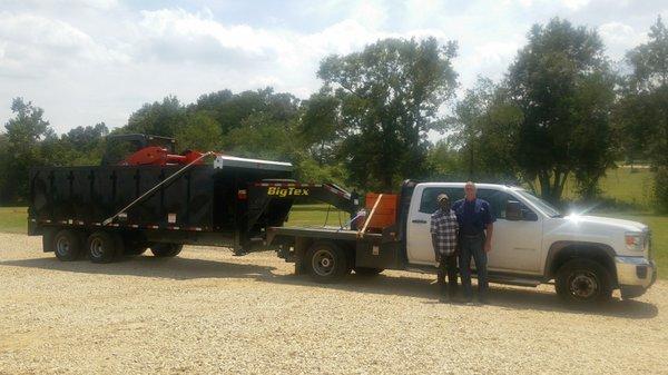 On their way to deliver a skid steer & roll-off dumpster to a job!