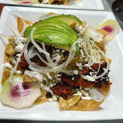 chilaquiles verdes w/ fresh onions, homemade chorizo and avocado.