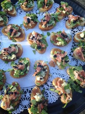 Fig & Goat Cheese Crostini with balsamic glaze, prosciutto & fresh arugula