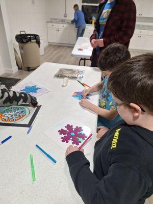 Making winter window sun catchers.