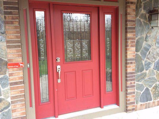 Another fiberglass entry door with 14" sidelights and brass caning in glass and decorative surround trim with recessed panel