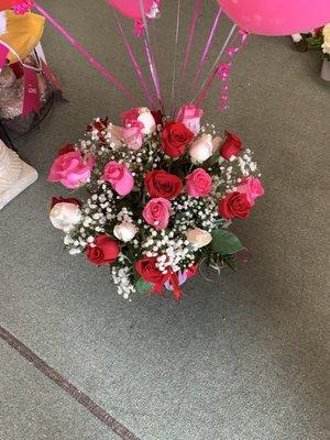 24 long stem roses with a bouquet of balloons in red pink and white.