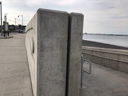 The entrance separated by the 10 foot tall seawall. Boulevard to the left beach to the right