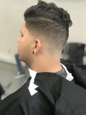 Medium low skin fade with comb over