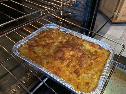 Mac and cheese , hot and fresh out of the oven.