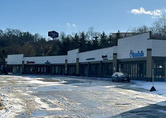 Some storefronts in the strip mall