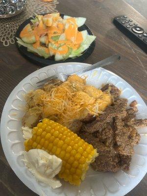 Roasted potatoes corn on the cob and steak