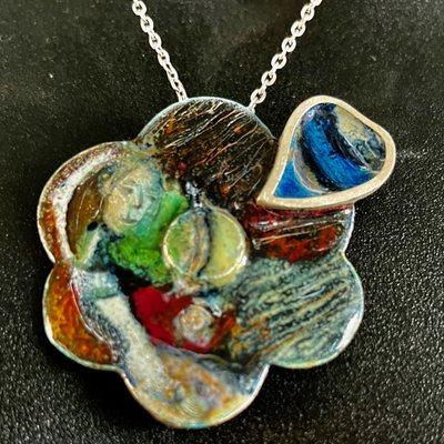 Sterling Silver piece with a abstract idea created with fired enamel.