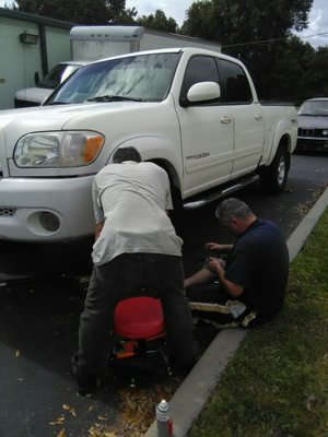 "working the front suspension ball joints, inner and outer tie rods on Toyota Tundra old school because another vehicle inside bay."