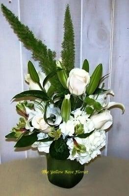 This design is made up of white lilies, white roses, green alstromeria and foxtail greens.