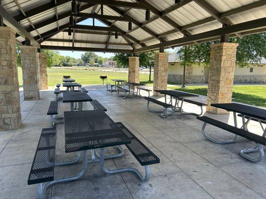 Large covered picnic table area with grills