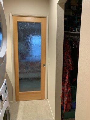 The pocket door looking from the bathroom next to the newly constructed laundry area.