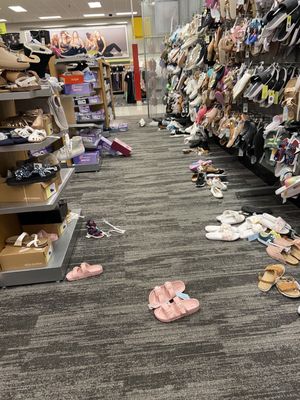 Shoe isle, shoes out of place and thrown everywhere.