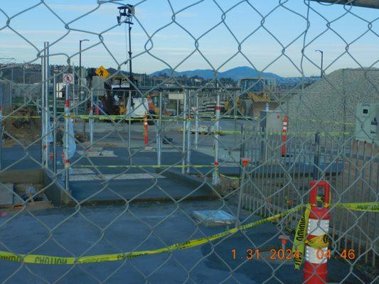 A back entrance to the Snap Drag0on stadium a crossing that should have announcements for those crossing of the trolley approaching.