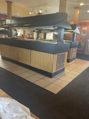 Lunch buffet area. One is pizza, pasta and bread. The other one is a salad bar.