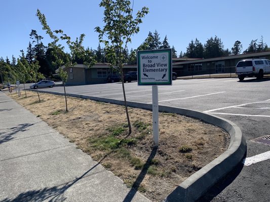 Sign marking visitor parking and staff parking.