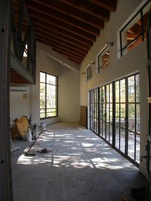 Center pivot window and terrace french doors, all made from steel.  Insul. double pane glass.