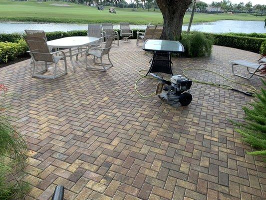 Pressure washing backyard patio deck.