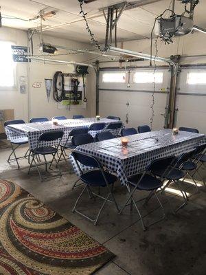 2 8' tables and 20 blue chairs with matching plastic table cloths