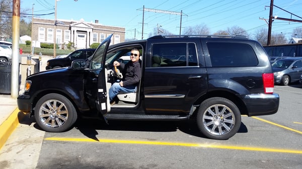 Our driver Alvi with one of our black luxury SUV's