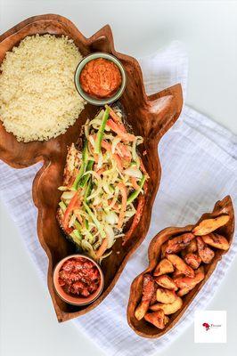 Barbecued fish with its vinaigrette and sides of cassava couscous and plantains. With our signature tomato sauce and hot pepper sauce