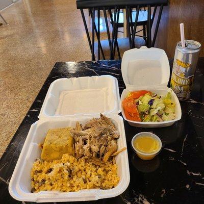 Mofongo (green plantains mashed with salt, garlic, broth, and oil, in a wooden pilon), pernil (pork), arroz con gandules, and a salad.