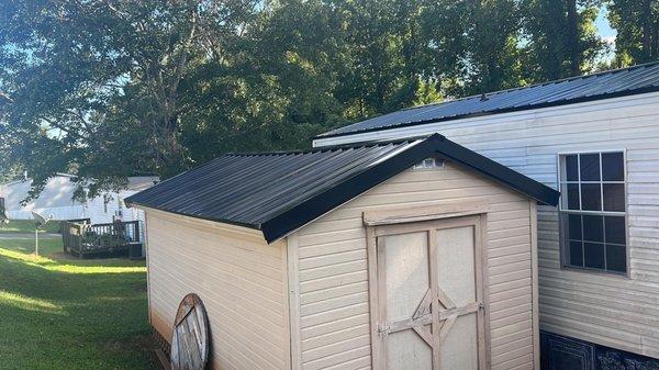 Mobile home and shed black metal roofing.