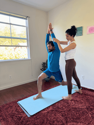 Guiding a practitioner in a 1 on 1 Yoga Session.