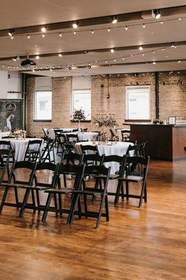 Tables and chairs set up for an event at FIVE Event Center in Minneapolis, Minnesota.