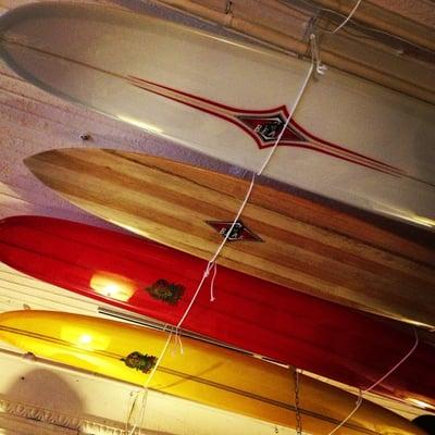 Wooden surf boards hanging on the ceiling.