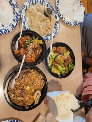 combination fried rice, sesame chicken, and a flat noodle dish with beef