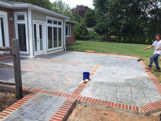 Stamped concrete patio with natural brick inlay