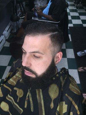 Bald fade with beard line up share and comb on top with combover part.