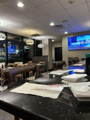 Seating area by the window and sushi bar