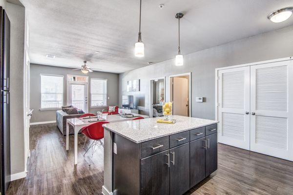 The kitchen with an island and a dining room in the background