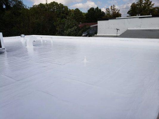 Liquid-applied applied silicone on asphalt roof.