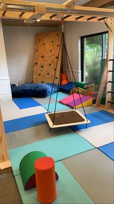 Our sensory gym promotes movement based learning and includes: swings, climbing ladders, monkey bars, a rock climbing wall, and more!