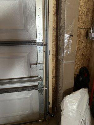 Bent frame after short rollers were installed where long rollers should have gone causing door detachment.