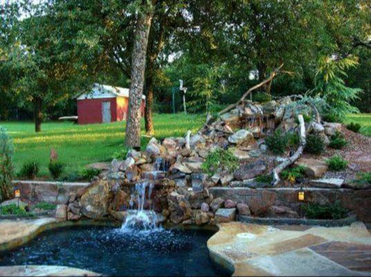 Hottub with waterfall retaining wall and flagstone patio