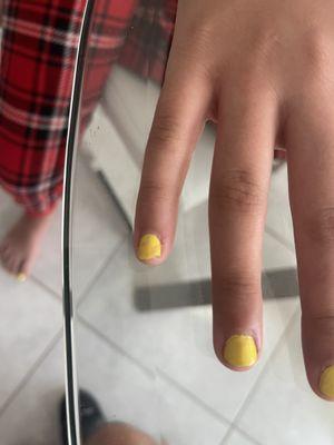 It was supposed to be yellow color but for some reason y see also a red on her pinky finger.